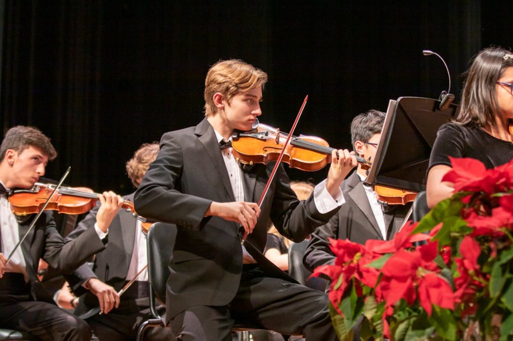 zipwp-image-4750559 A group of young musicians performing in a live orchestra with violins.